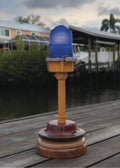 Series II 4 of 12 - blue runway light on wooden base